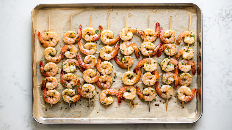 shrimp skewers on pan