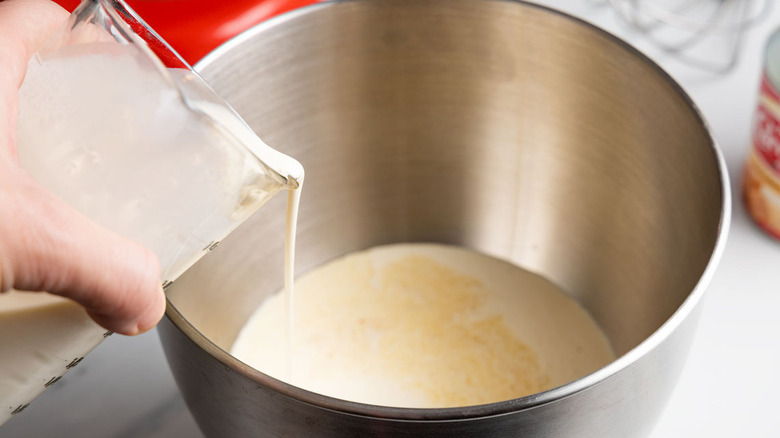 combining milk, cream, and vanilla
