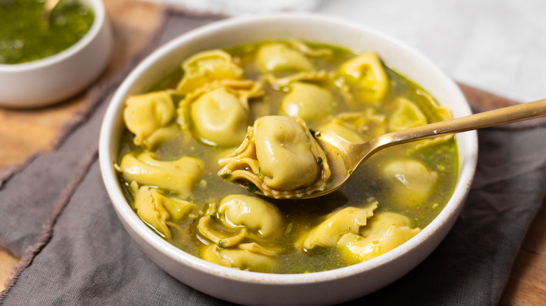 spoon with tortellini soup