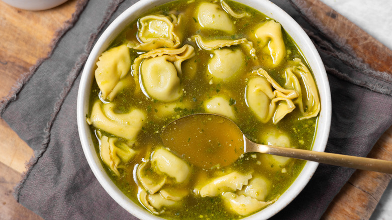 spoon in tortellini soup bowl