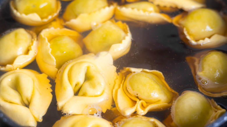 tortellini cooking in broth