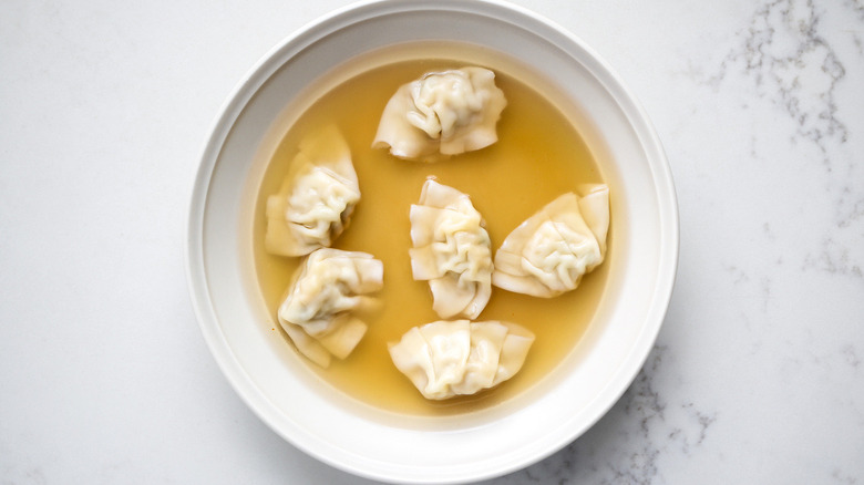dumpling soup in white bowl