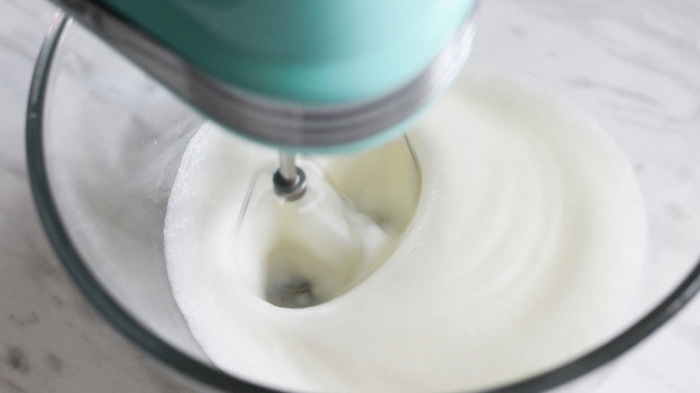 egg whites being beaten to peaks in bowl