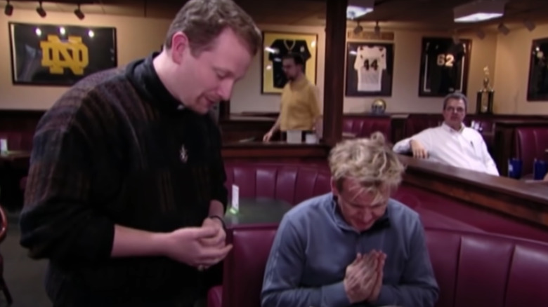 Gordon Ramsay praying with a priest