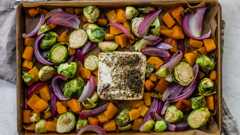 Feta and vegetables on baking sheet