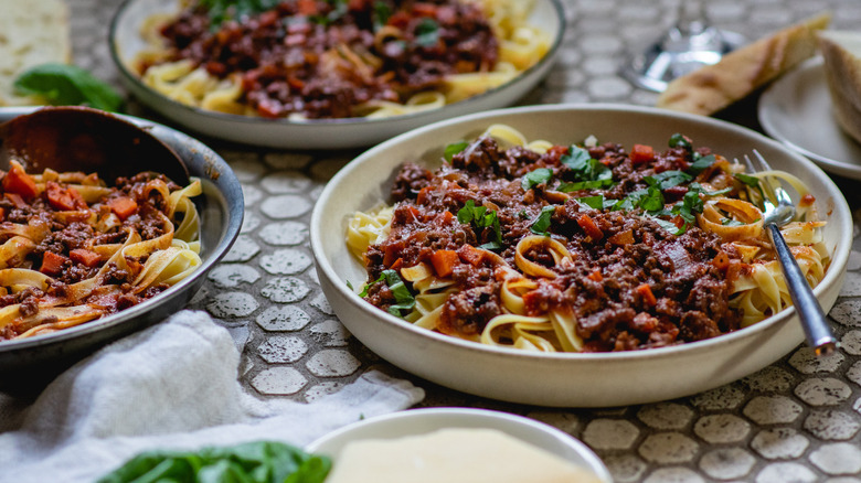 Pasta Bolognese in white and black bowls