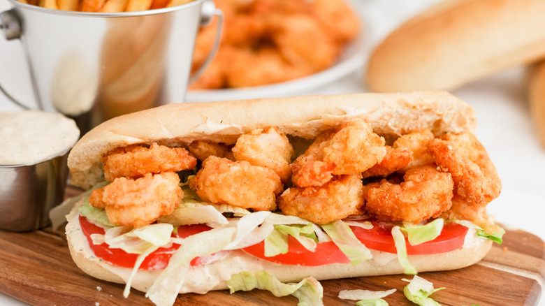 Sub sandwich with fried shrimp and veggies.