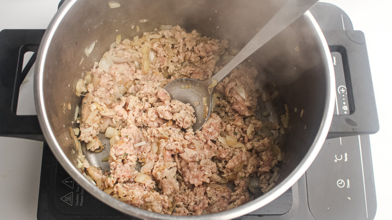 sausages cooking with onions