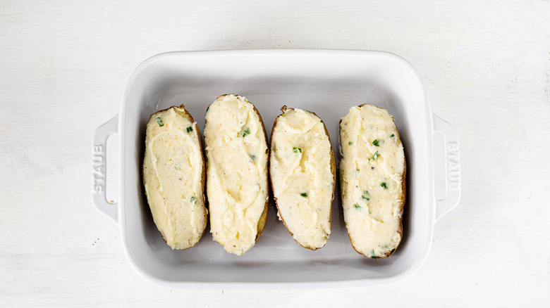 Filled potatoes in baking pan