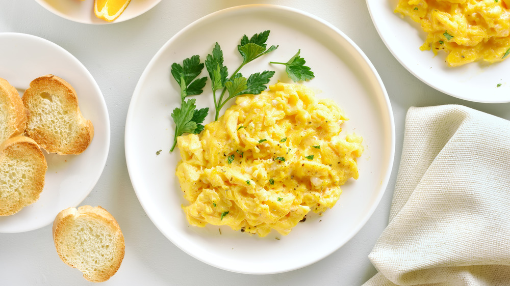 Scrambled eggs with white plates