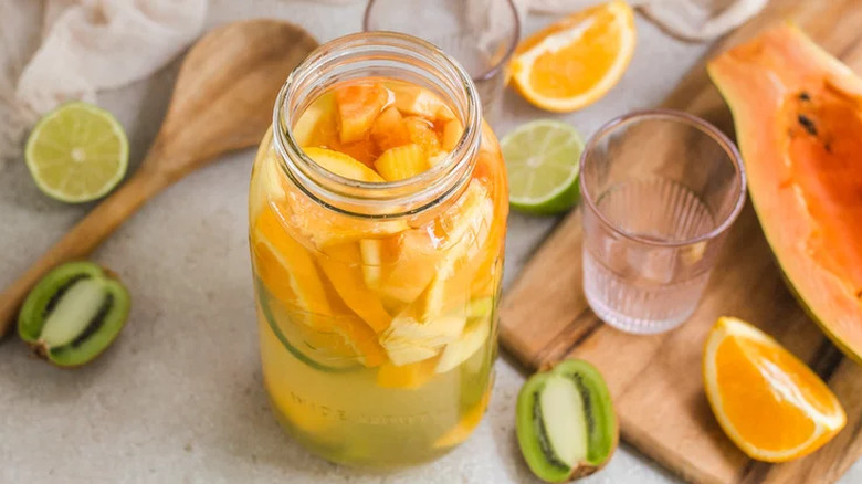 Mason jar with sliced fruit and wine, 