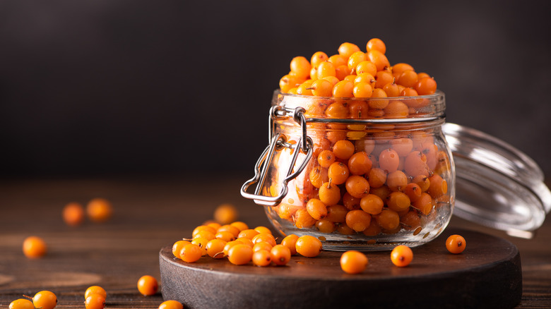 sea buckthorn berries in a glass jar