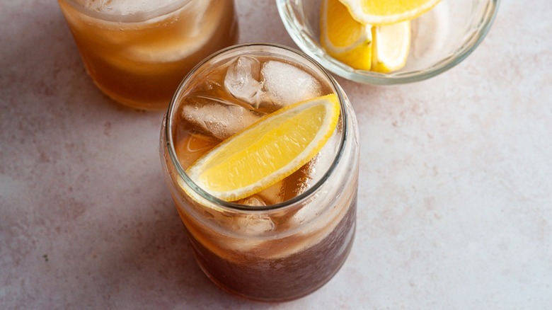 brown drink in tall glass