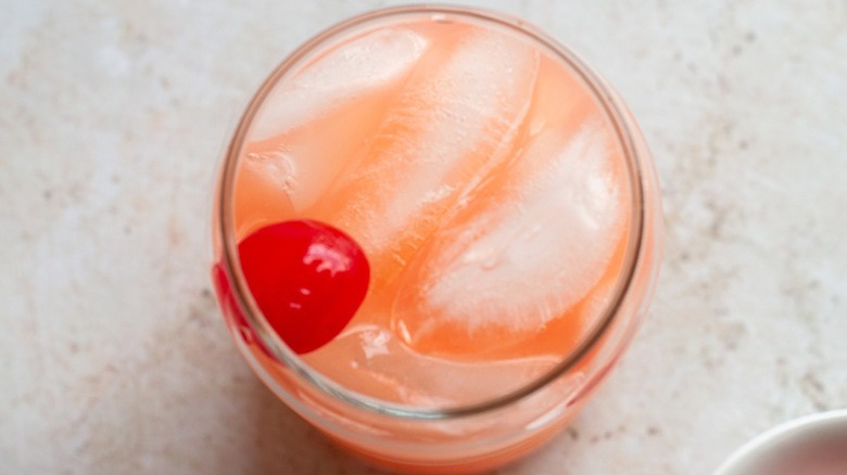 pink drink with maraschino cherry