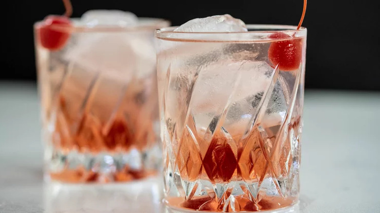 Old Fashioned glasses with grenadine and cherries