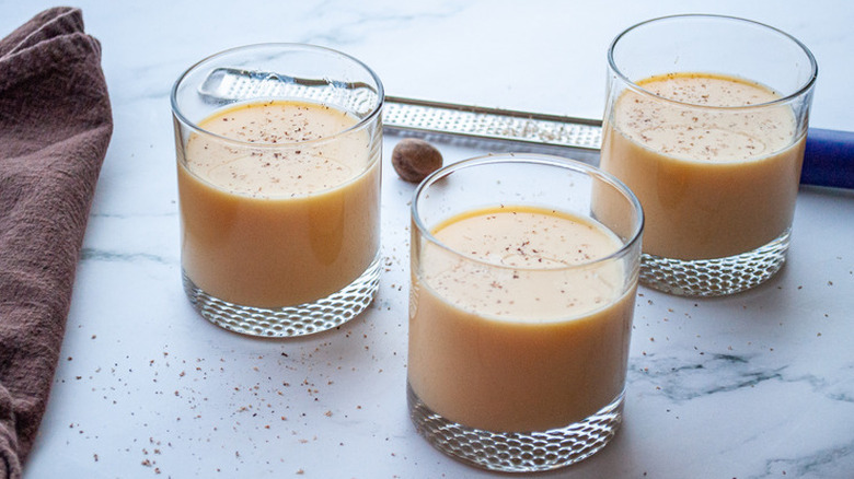 Three glasses of eggnog with nutmeg