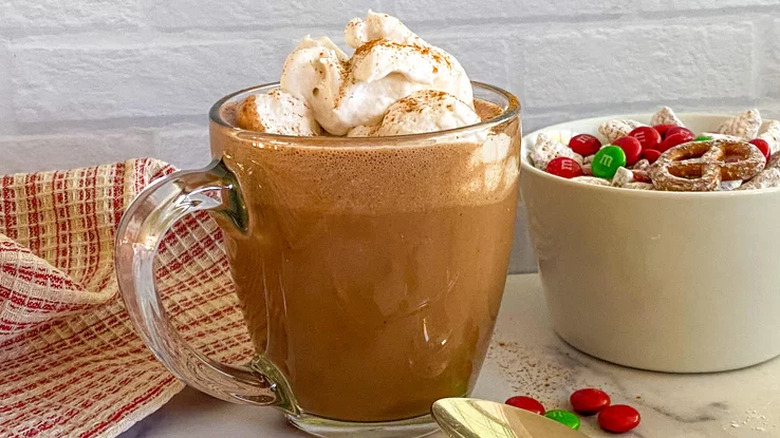 Glass mug of hot chocolate and whipped cream