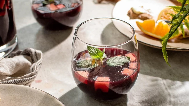 Glass of red sangria with mint and fruit