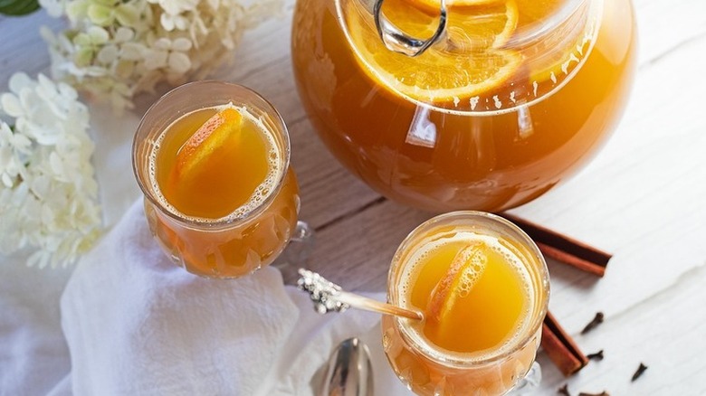 Glasses and pitcher with tea and orange slices