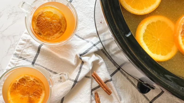 Cider in slow cooker and in two glass mugs