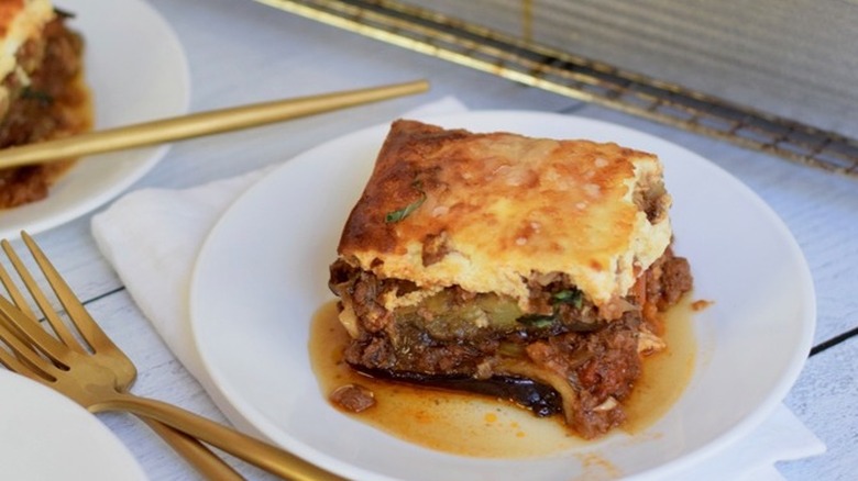 Sliced of moussaka layered casserole on a plate.