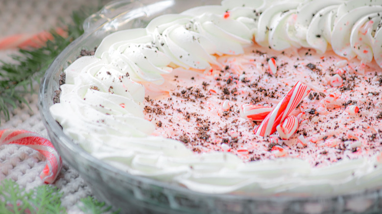 Pink pie filling with whipped cream and crushed candy canes.