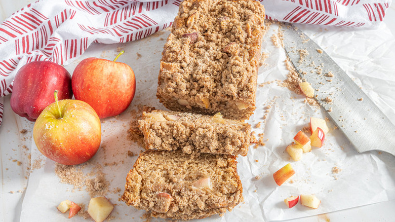 Sliced loaf of apple bread with crumbly topping. 