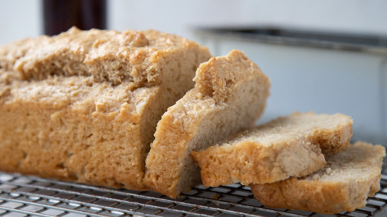 Light brown loaf of sliced beer bread. 