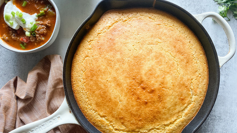 Enameled cast iron skillet with baked cornbread.