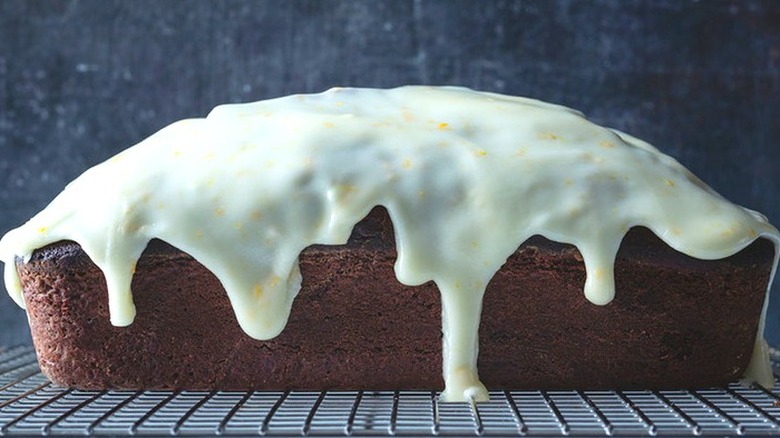 Chocolate quick bread loaf with thick white glaze. 