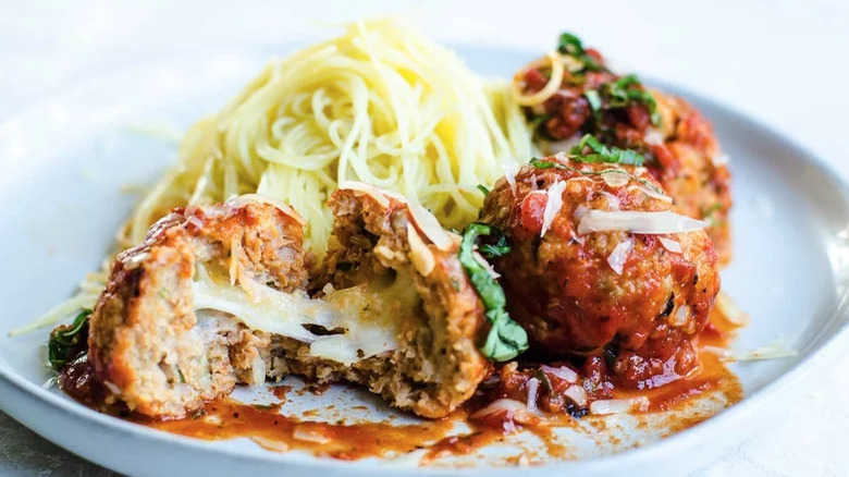 Cheese-stuffed meatballs with spaghetti