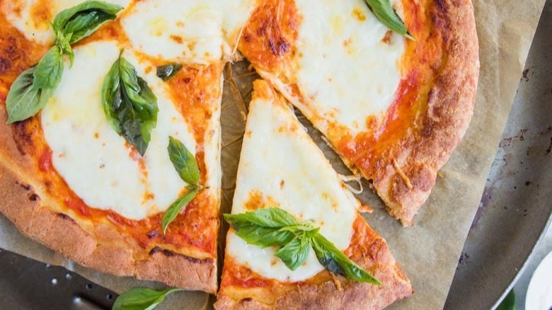 sliced margherita pizza on paper