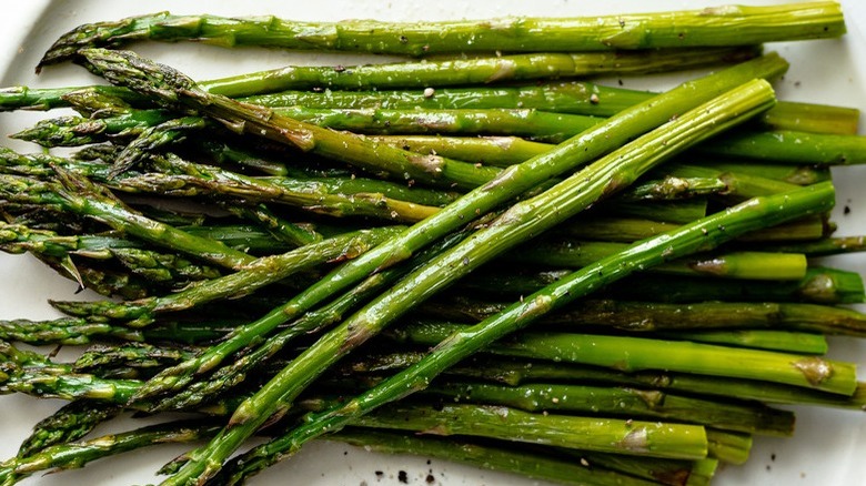 cooked asparagus on white platter