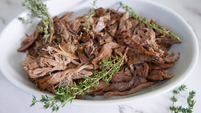 braised lamb with herb garnish