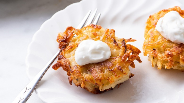 two latkes with sour cream