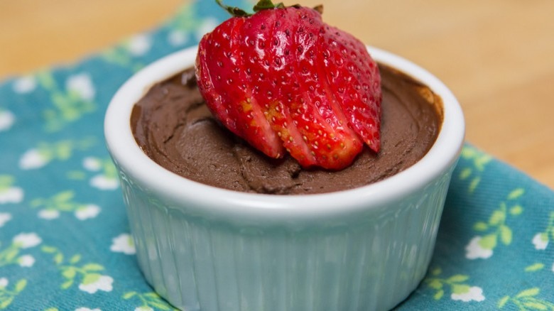 White dish of chocolate mousse and berries