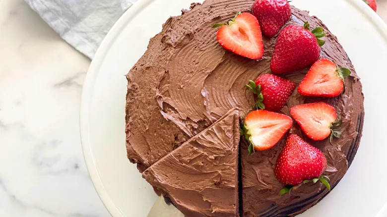 Round frosted chocolate cake with berries