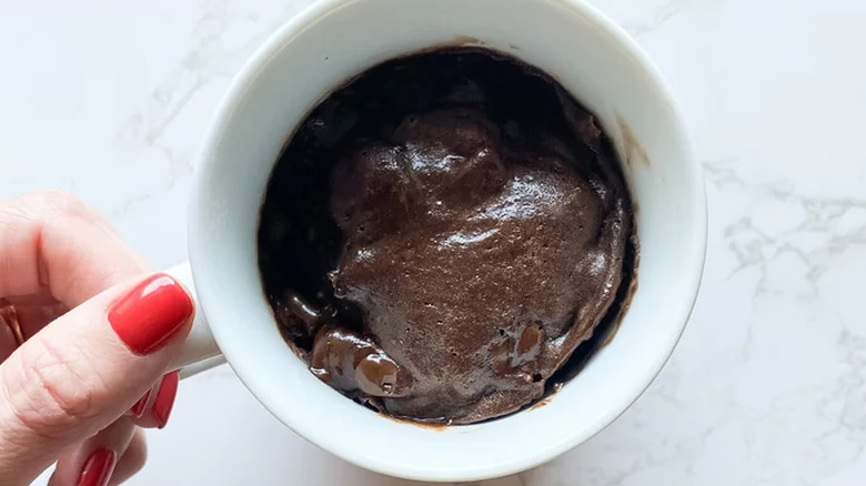 White mug with cooked brownie inside