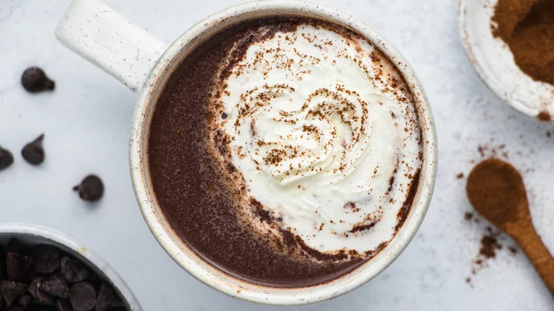 White mug of hot chocolate and cream