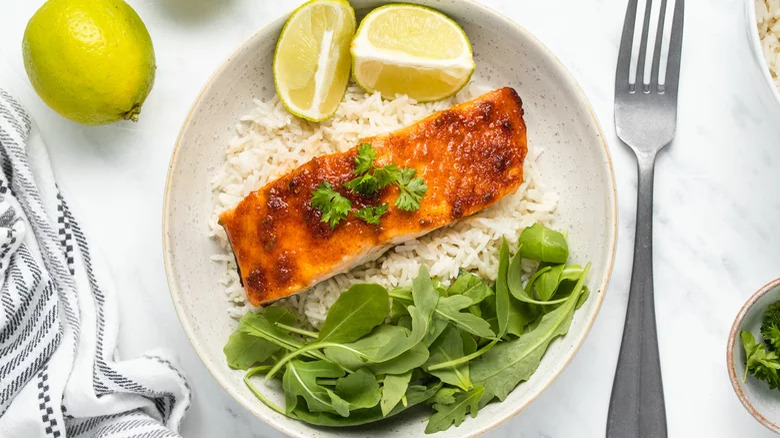 Spicy baked salmon with rice and lime