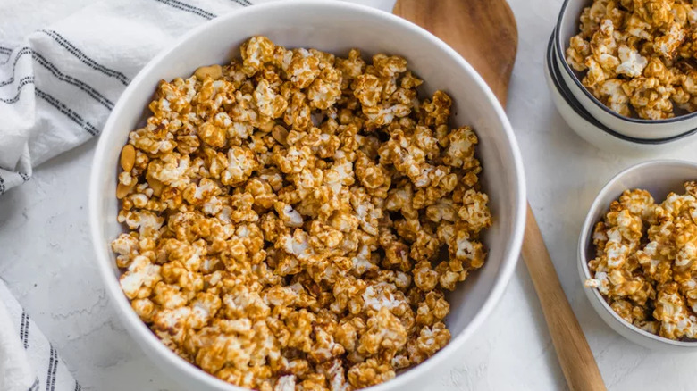 White bowl of peanut butter coated popcorn