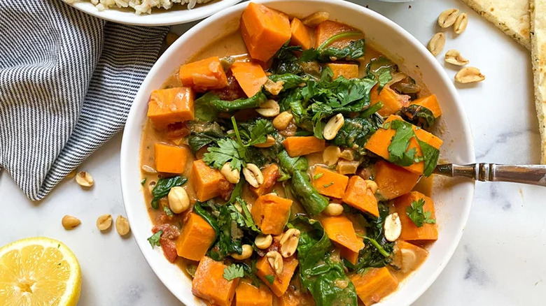 White bowl of sweet potato and peanut stew