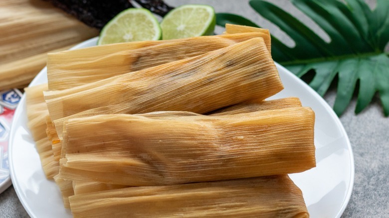 wrapped tamales on white plate