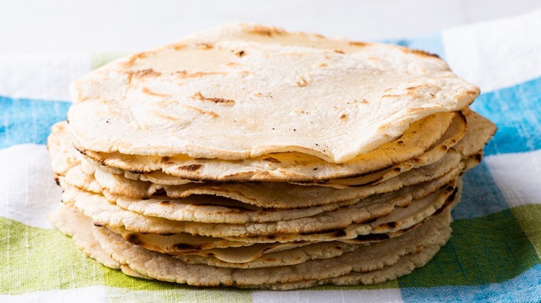 corn tortillas on striped towel