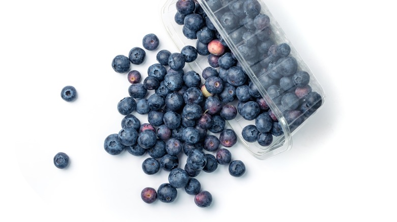 Spilling box of blueberries 