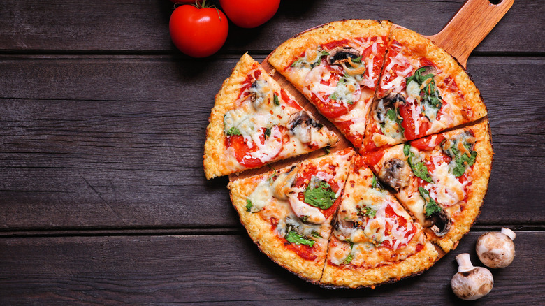 Cauliflower pizza, tomatoes and mushrooms