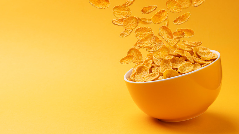 Cornflakes falling into bowl