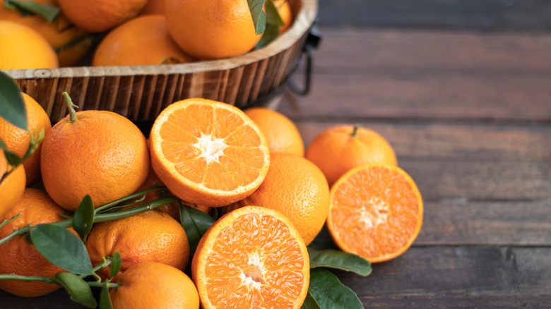 Sliced and whole oranges