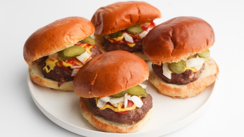 hamburgers with pickles and onions