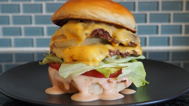 tall burger with drippy dressing